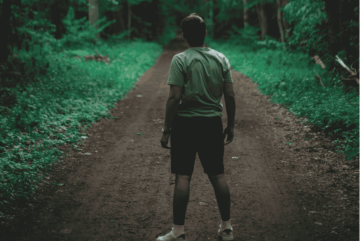 man jogging through a forest