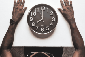 man looking at a clock on a table