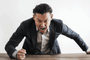 man-bangs-desk-in-fury