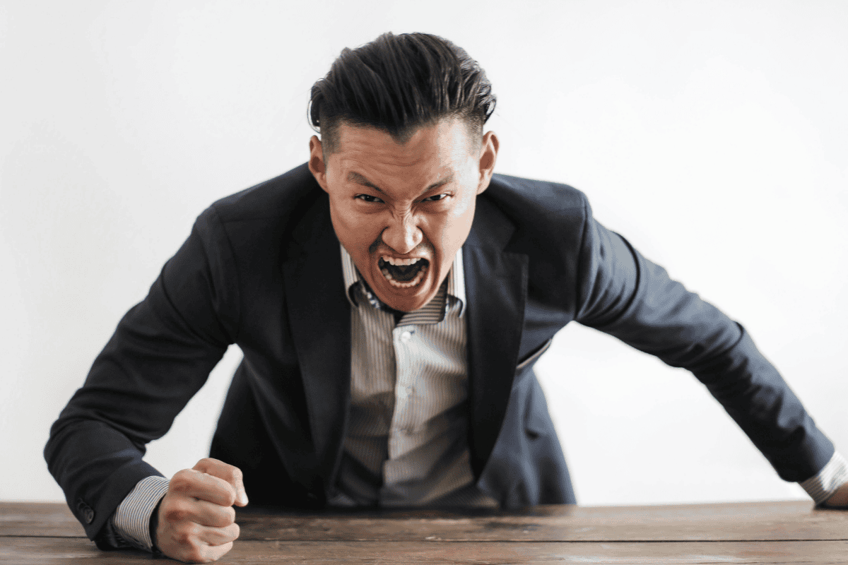 man-bangs-desk-in-fury