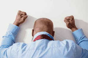 man-beating-fists-against-wall